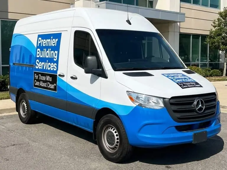 Premier Building Services van outside a commercial facility